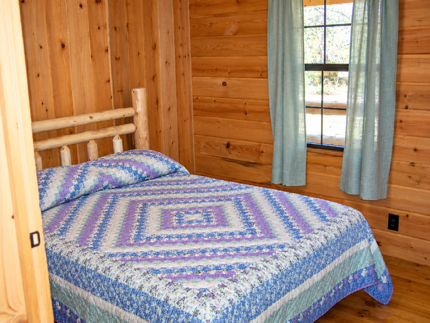 Downstairs master bedroom inside Kindling Trail Cabin